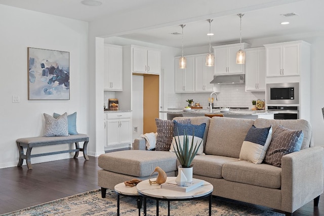 4409 Arques Ave, Round Rock, TX 78681 - living room with dark wood-style floors and recessed lighting