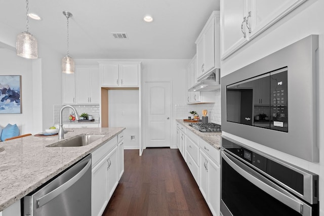 4409 Arques Ave, Round Rock, TX 78681 - kitchen featuring appliances with stainless steel finishes, dark wood finished floors, white cabinets, and recessed lighting