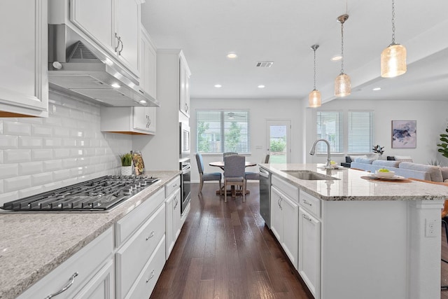 4409 Arques Ave, Round Rock, TX 78681 - kitchen with stainless steel appliances, range hood, dark wood finished floors, backsplash, and white cabinetry