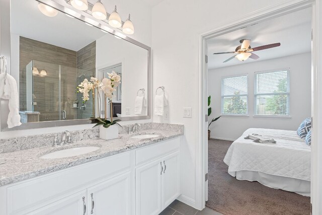 4409 Arques Ave, Round Rock, TX 78681 - ensuite bathroom with double vanity, a shower stall, and a ceiling fan