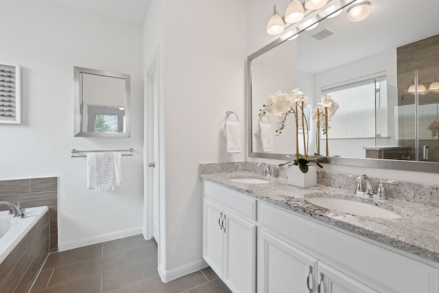 4409 Arques Ave, Round Rock, TX 78681 - full bathroom with double vanity, a garden tub, tile patterned floors, and a shower with shower door