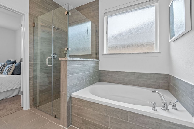 4409 Arques Ave, Round Rock, TX 78681 - ensuite bathroom featuring a garden tub, a shower stall, and tile patterned floors