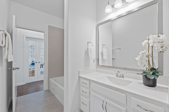 4409 Arques Ave, Round Rock, TX 78681 - bathroom with vanity, french doors, tile patterned flooring, and bathing tub / shower combination