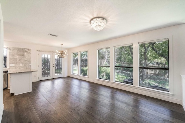 10703 Keystone Bnd, Austin, TX 78750 - unfurnished dining area with a chandelier, french doors, and dark wood finished floors