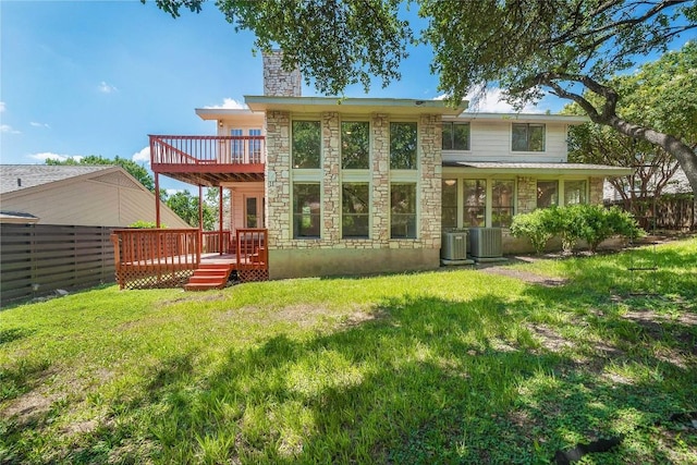10703 Keystone Bnd, Austin, TX 78750 - rear view of property featuring stone siding, a chimney, and a deck