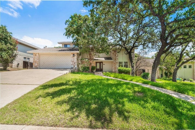 10703 Keystone Bnd, Austin, TX 78750 - view of front facade featuring an attached garage, concrete driveway, a front lawn, and stone siding