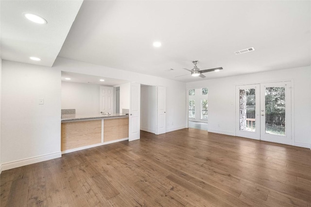 10703 Keystone Bnd, Austin, TX 78750 - unfurnished living room featuring ceiling fan, recessed lighting, wood finished floors, and french doors