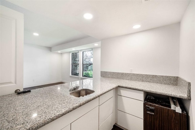 10703 Keystone Bnd, Austin, TX 78750 - kitchen with recessed lighting, white cabinetry, and light stone counters