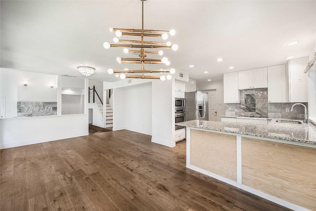 10703 Keystone Bnd, Austin, TX 78750 - kitchen featuring stainless steel appliances, white cabinetry, backsplash, light stone counters, and recessed lighting