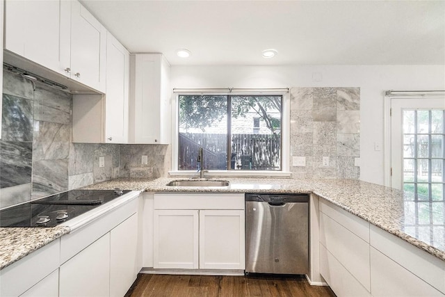 10703 Keystone Bnd, Austin, TX 78750 - kitchen featuring dishwasher, black electric stovetop, decorative backsplash, white cabinetry, and light stone countertops