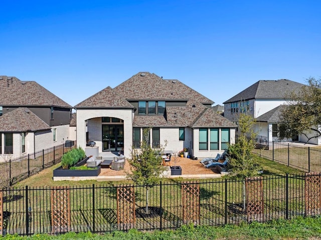 rear view of house featuring a patio, an outdoor hangout area, and a fenced backyard