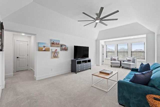 living room featuring vaulted ceiling, a ceiling fan, and light colored carpet