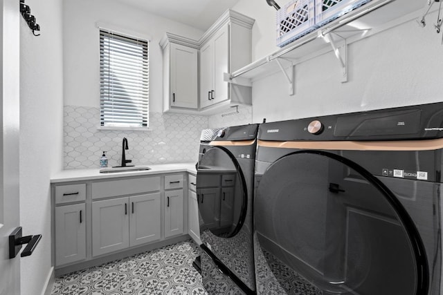laundry area with separate washer and dryer, cabinet space, and light tile patterned flooring