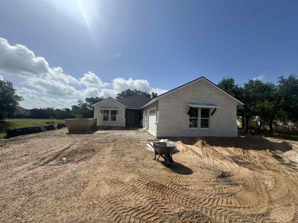 226 Sunday Dr, Burnet, TX 78611 - view of front of property featuring an attached garage and stone siding
