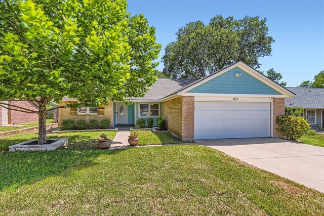 1121 Stoneoak Ln, Austin, TX 78745 - view of front of property featuring an attached garage, driveway, a front yard, and brick siding
