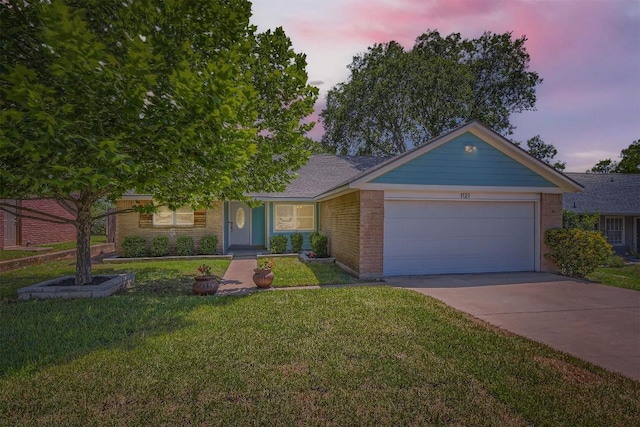1121 Stoneoak Ln, Austin, TX 78745 - view of front of property featuring an attached garage, concrete driveway, a front lawn, and brick siding