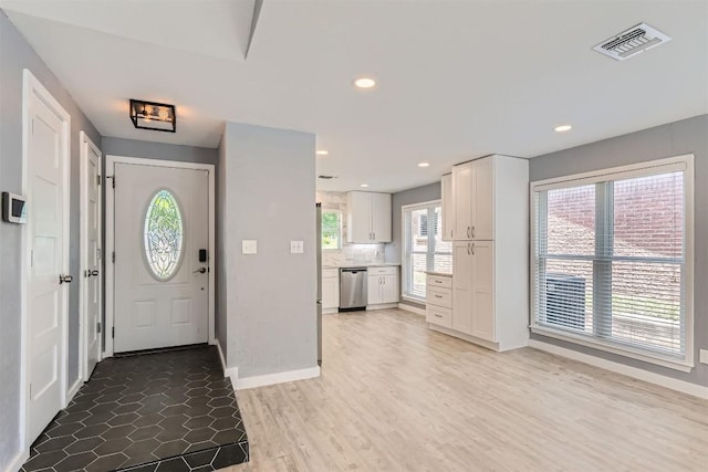 1121 Stoneoak Ln, Austin, TX 78745 - entryway with light wood-style flooring and recessed lighting