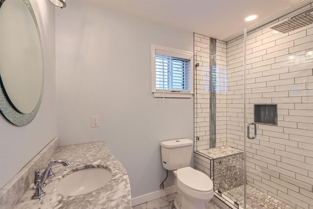 1121 Stoneoak Ln, Austin, TX 78745 - bathroom featuring a shower stall, vanity, marble finish floors, and recessed lighting