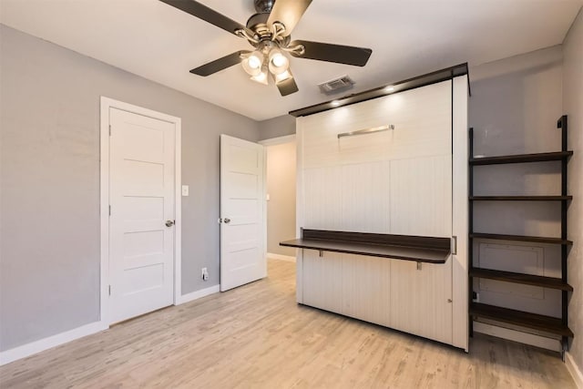 1121 Stoneoak Ln, Austin, TX 78745 - unfurnished bedroom featuring light wood-style floors and a ceiling fan