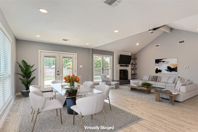 1121 Stoneoak Ln, Austin, TX 78745 - dining area with light wood-style flooring, french doors, a fireplace, and recessed lighting