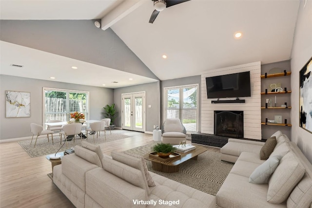 1121 Stoneoak Ln, Austin, TX 78745 - living room featuring wood finished floors, beam ceiling, recessed lighting, ceiling fan, and a large fireplace