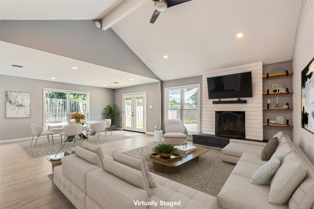 1121 Stoneoak Ln, Austin, TX 78745 - living area featuring wood finished floors, beamed ceiling, recessed lighting, a ceiling fan, and a large fireplace