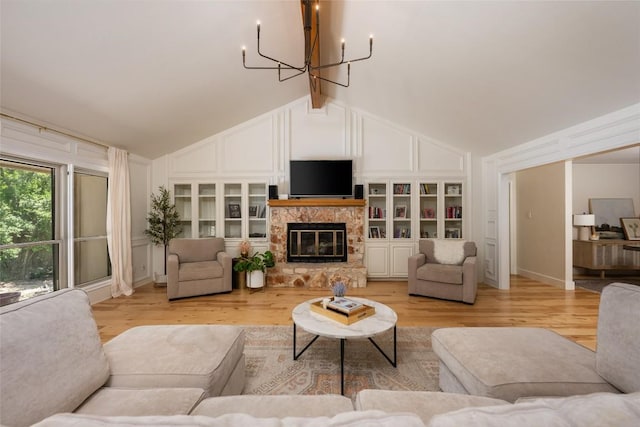 6317 Gato Path, Austin, TX 78731 - living area with a chandelier, a stone fireplace, and light wood finished floors