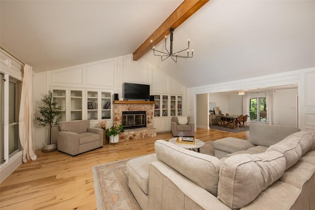 6317 Gato Path, Austin, TX 78731 - living area with a chandelier, light wood-style flooring, a glass covered fireplace, a decorative wall, and built in shelves