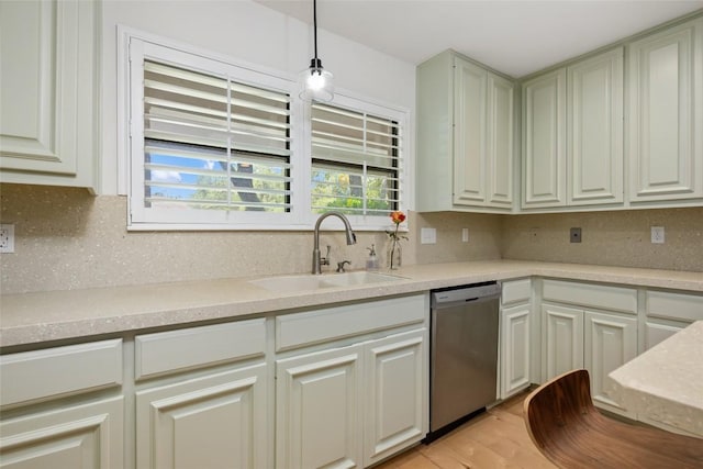 6317 Gato Path, Austin, TX 78731 - kitchen with stainless steel dishwasher, decorative backsplash, light countertops, light wood-style floors, and pendant lighting
