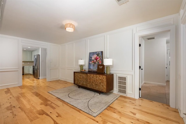 6317 Gato Path, Austin, TX 78731 - hall with a decorative wall and light wood-style flooring