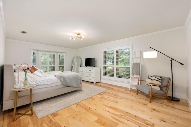 6317 Gato Path, Austin, TX 78731 - bedroom featuring light wood-style floors, ornamental molding, and a chandelier