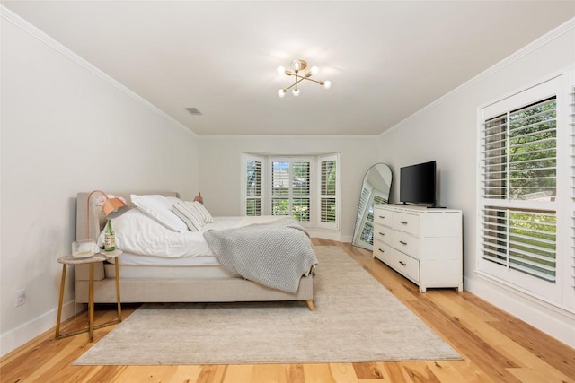 6317 Gato Path, Austin, TX 78731 - bedroom with light wood finished floors, ornamental molding, and a chandelier