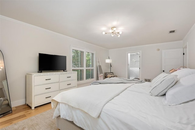6317 Gato Path, Austin, TX 78731 - bedroom featuring crown molding, light wood-style floors, and a chandelier