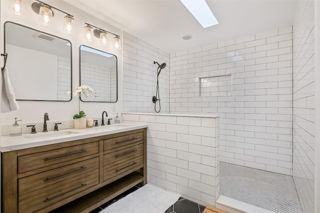 6317 Gato Path, Austin, TX 78731 - bathroom with walk in shower, double vanity, a skylight, and tile walls