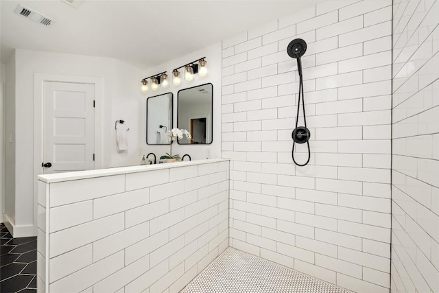 6317 Gato Path, Austin, TX 78731 - bathroom featuring tiled shower and tile patterned floors