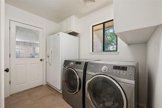6317 Gato Path, Austin, TX 78731 - laundry area with washer and clothes dryer, cabinet space, and light tile patterned floors