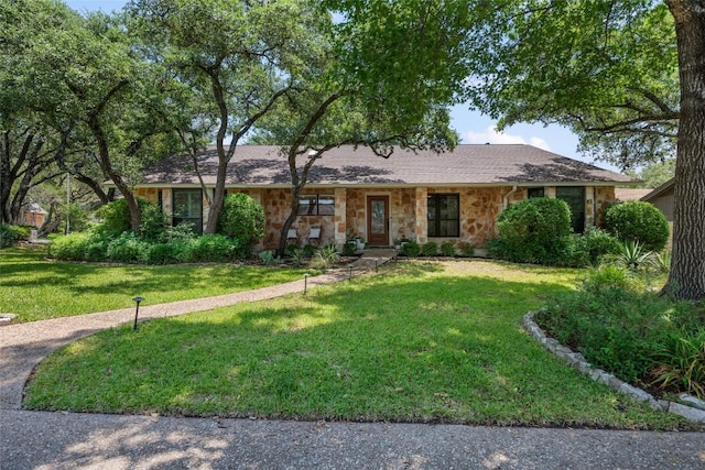 6317 Gato Path, Austin, TX 78731 - ranch-style home with stone siding and a front lawn