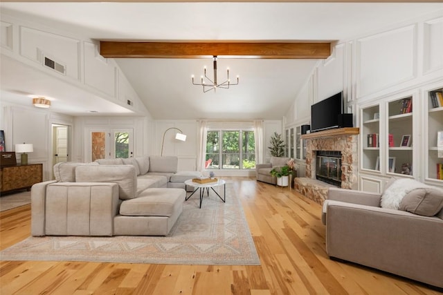 6317 Gato Path, Austin, TX 78731 - living room featuring a chandelier, beam ceiling, light wood-style floors, a fireplace, and a decorative wall