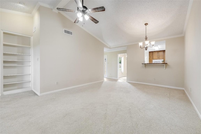 45 Oaks Pl, Lago Vista, TX 78645 - unfurnished living room featuring carpet floors, a textured ceiling, a chandelier, built in features, and crown molding