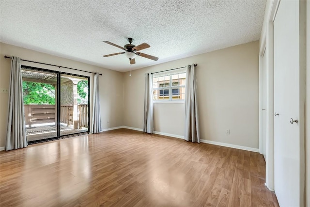 45 Oaks Pl, Lago Vista, TX 78645 - empty room featuring ceiling fan, wood finished floors, and a textured ceiling