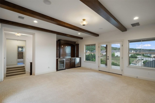 6000 Osceola Trl, Austin, TX 78738 - unfurnished living room featuring wine cooler, light colored carpet, beamed ceiling, healthy amount of natural light, and recessed lighting