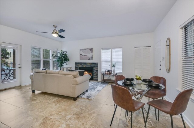 3115 Tom Green St Unit 202, Austin, TX 78705 - living area featuring ceiling fan, plenty of natural light, a fireplace, and light tile patterned floors