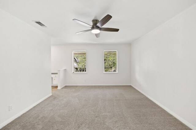 4217 Greystone Dr N, Austin, TX 78731 - empty room with a ceiling fan, crown molding, and light colored carpet