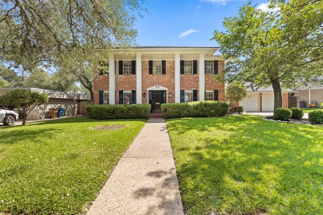 4217 Greystone Dr N, Austin, TX 78731 - neoclassical / greek revival house featuring brick siding and a front yard