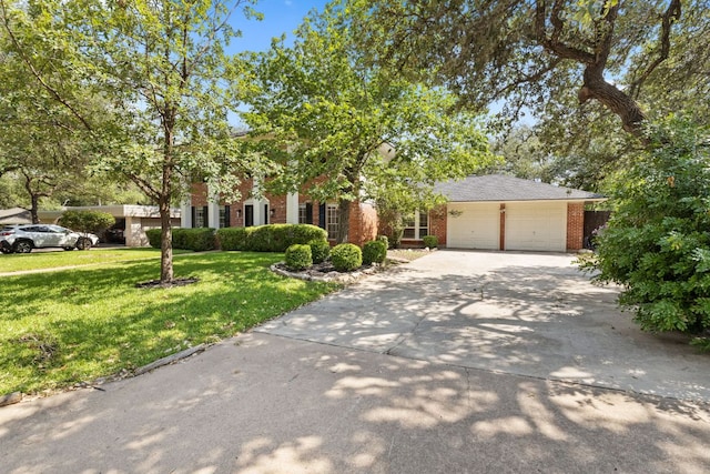 4217 Greystone Dr N, Austin, TX 78731 - view of front facade with brick siding, driveway, a garage, and a front yard