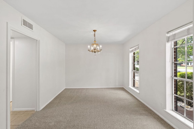 4217 Greystone Dr N, Austin, TX 78731 - spare room featuring a chandelier and light carpet