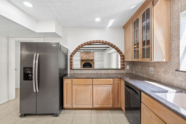 4217 Greystone Dr N, Austin, TX 78731 - kitchen featuring stainless steel fridge with ice dispenser, black dishwasher, light tile patterned flooring, backsplash, and glass insert cabinets