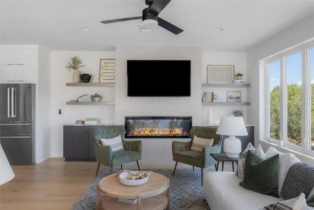 7809 Old Bee Caves Rd Unit 12, Austin, TX 78735 - living area with wood finished floors, ceiling fan, a glass covered fireplace, and recessed lighting