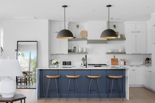 7809 Old Bee Caves Rd Unit 12, Austin, TX 78735 - kitchen with open shelves, modern cabinets, custom exhaust hood, a kitchen bar, and white cabinets
