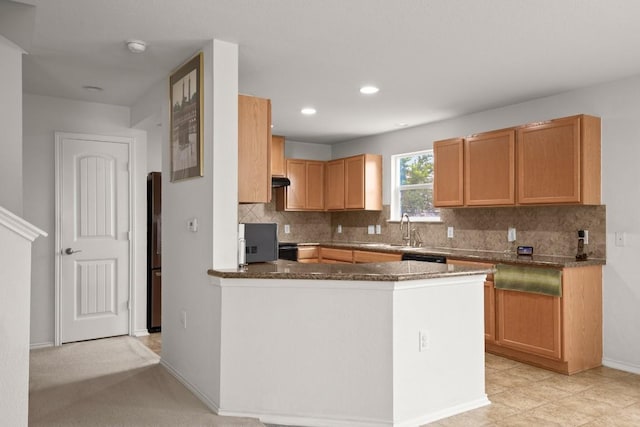 11104 Helms Deep Dr, Austin, TX 78754 - kitchen featuring tasteful backsplash, dark stone countertops, a peninsula, freestanding refrigerator, and recessed lighting